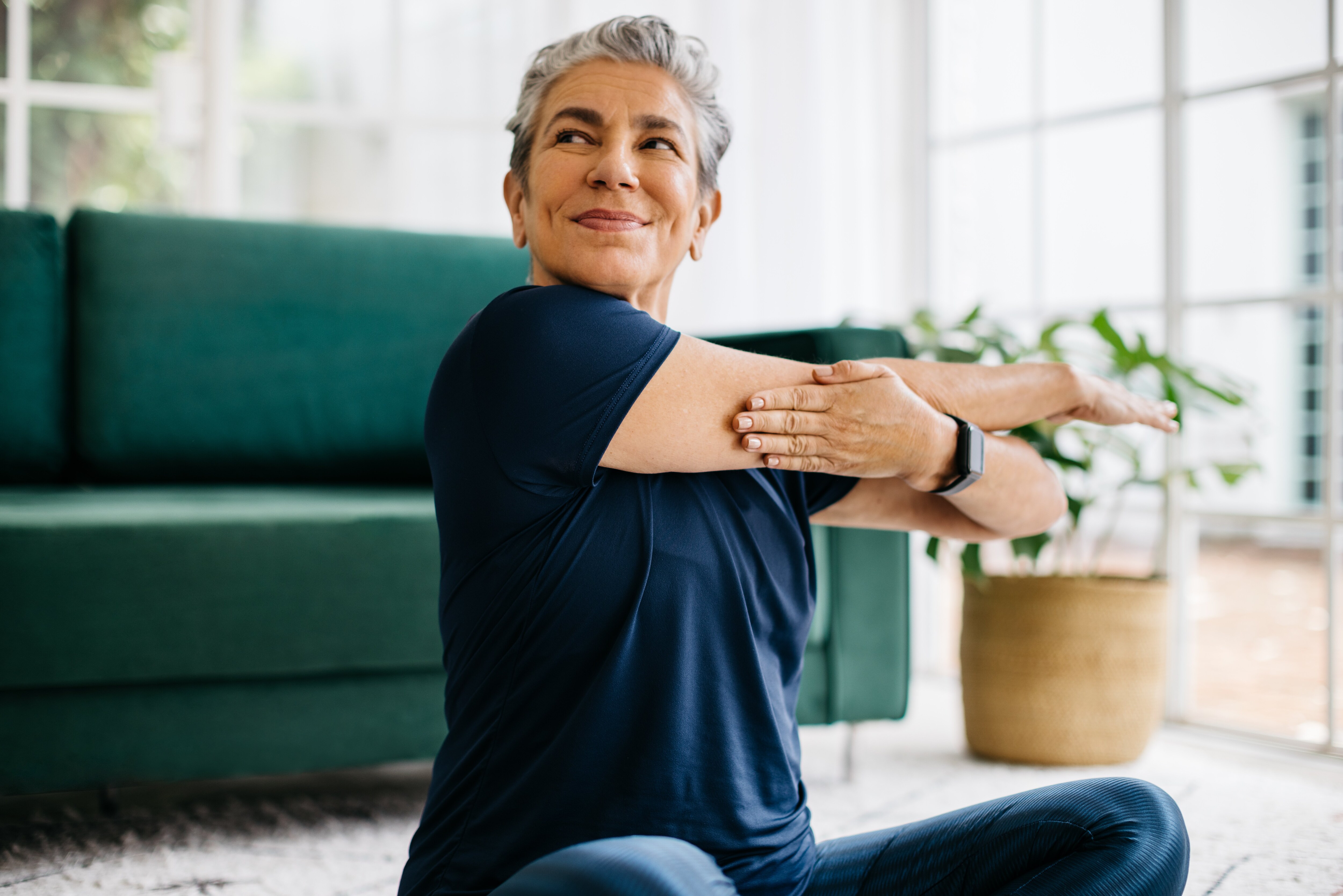 Woman Stretching indoors.