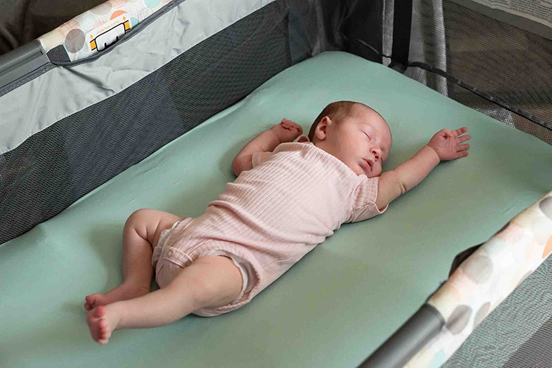 Infant sleeps safely in a crib